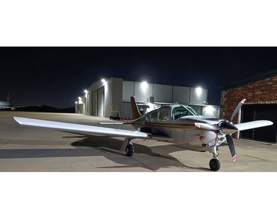 Aircraft parked outside the hangar at night